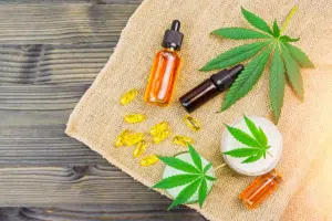 a group of bottles with a dropper next to a leaf